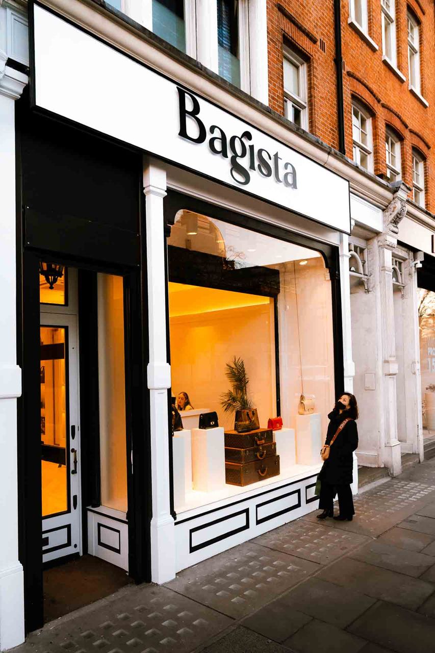 Boutique shopfront lit at night on a London street
